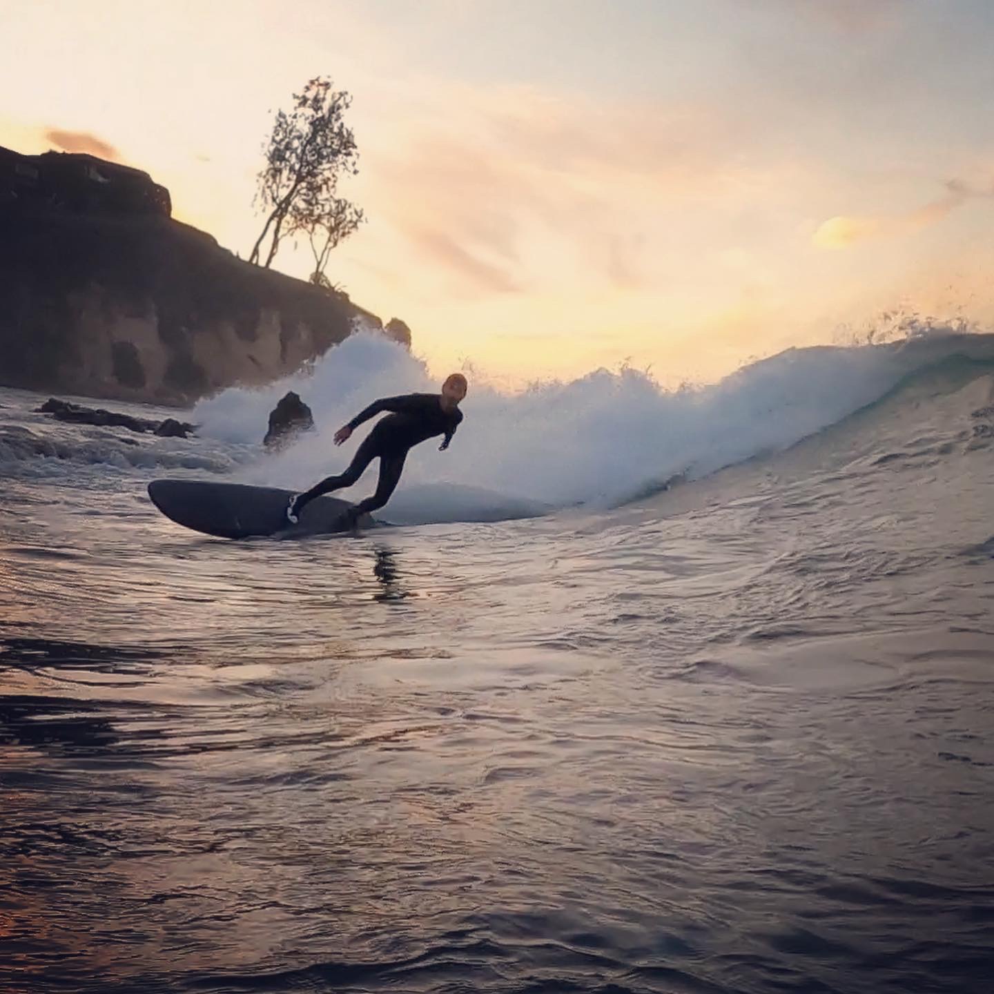 Surfer riding a VESL Soft Top Longboard on a clean wave
